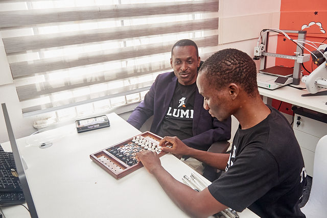 Mr Adedamola playing chess with Mr Asorobi